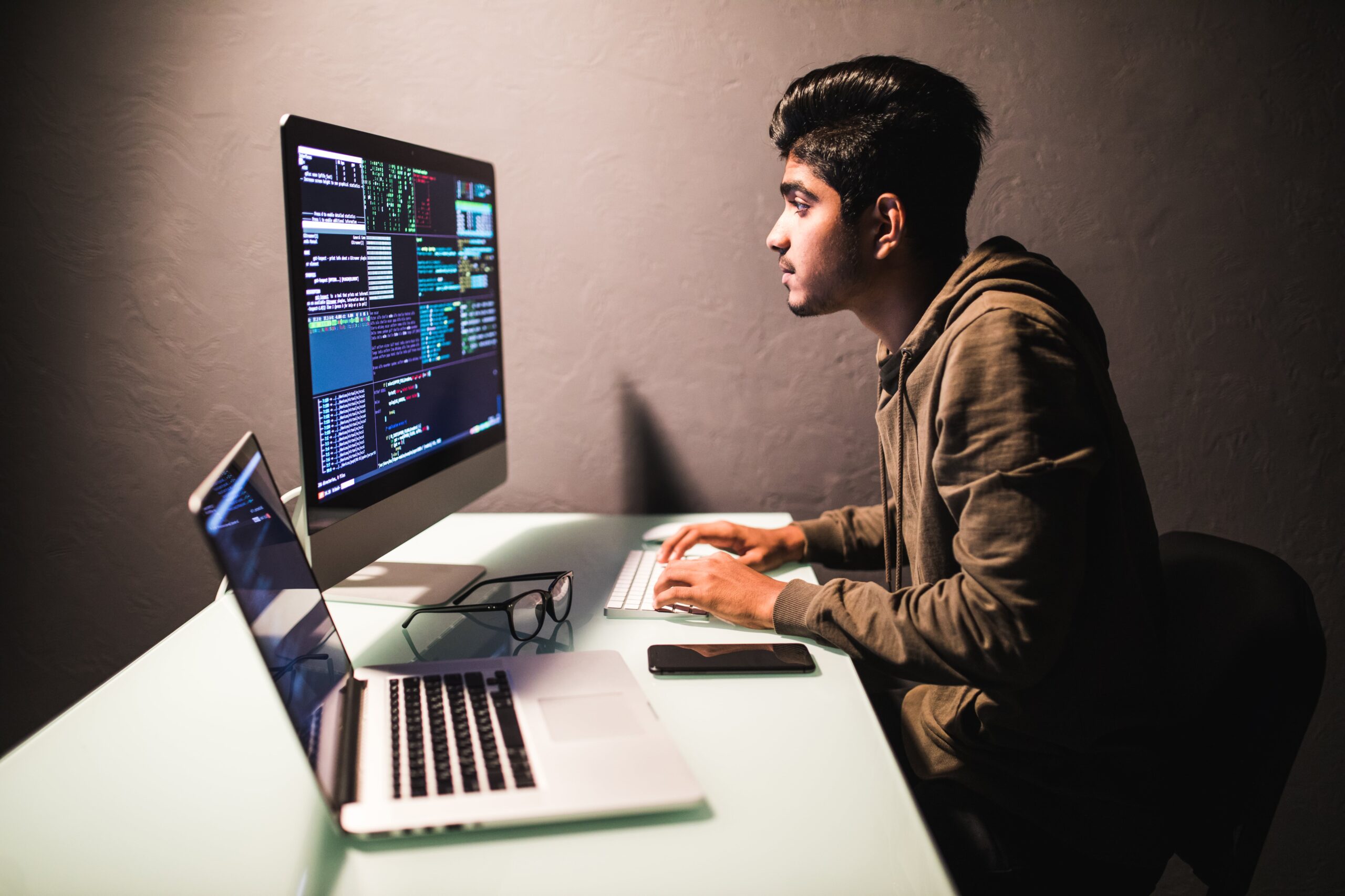 program-development-concept-young-indian-man-working-with-computer-min