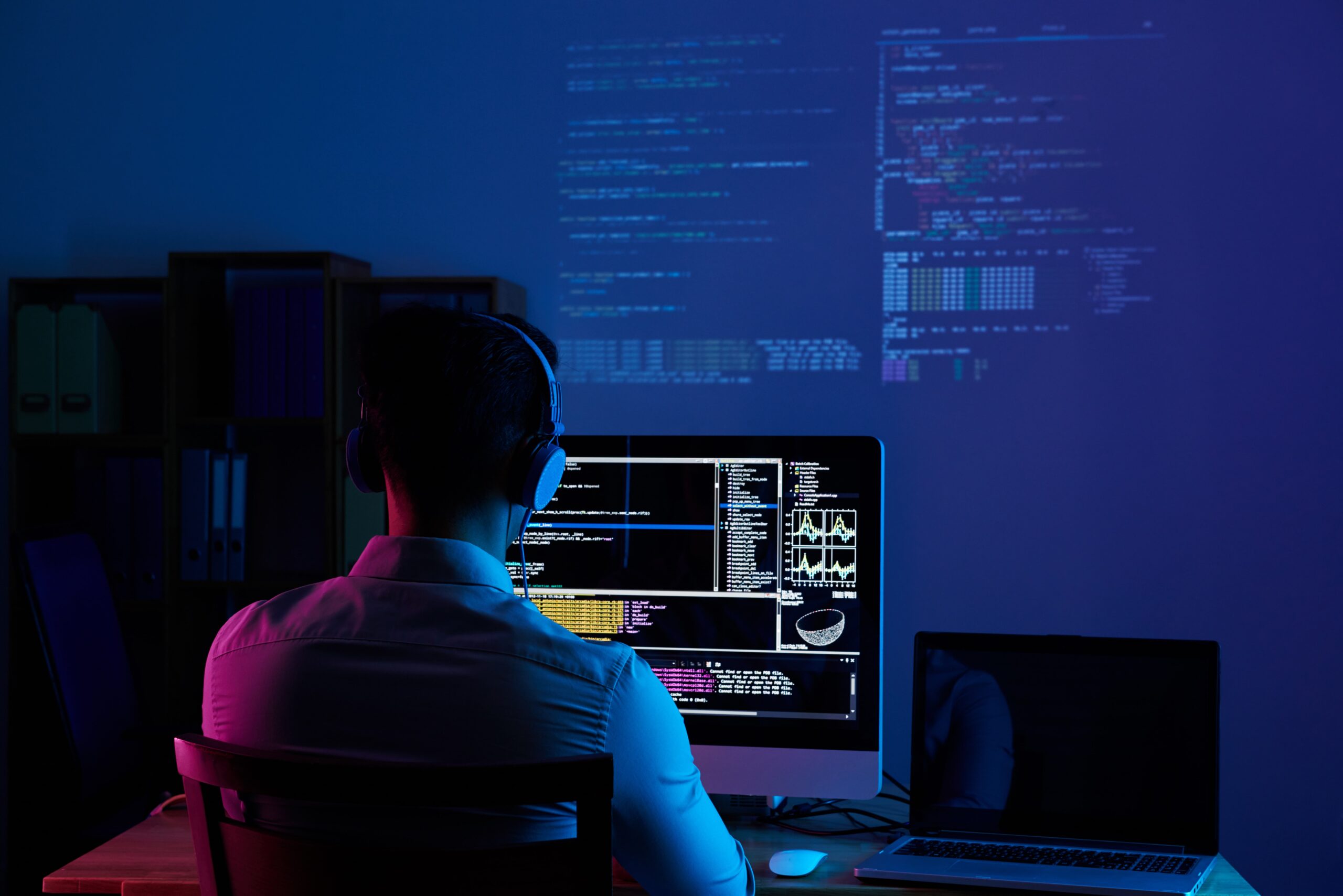 rear-view-programmer-working-all-night-long-min